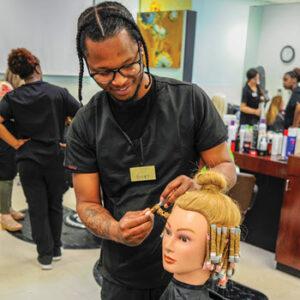 Cosmetology student working on mannequin