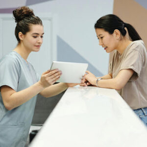 Two med students having a discussion at the desk