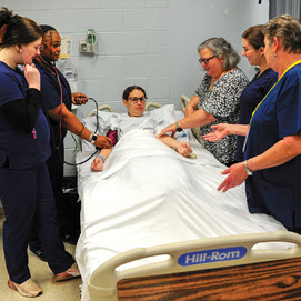 Healthcare students treating a patient