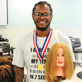 Student DeLante Grant standing with mannequin head