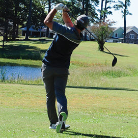 Golfer swinging golf club